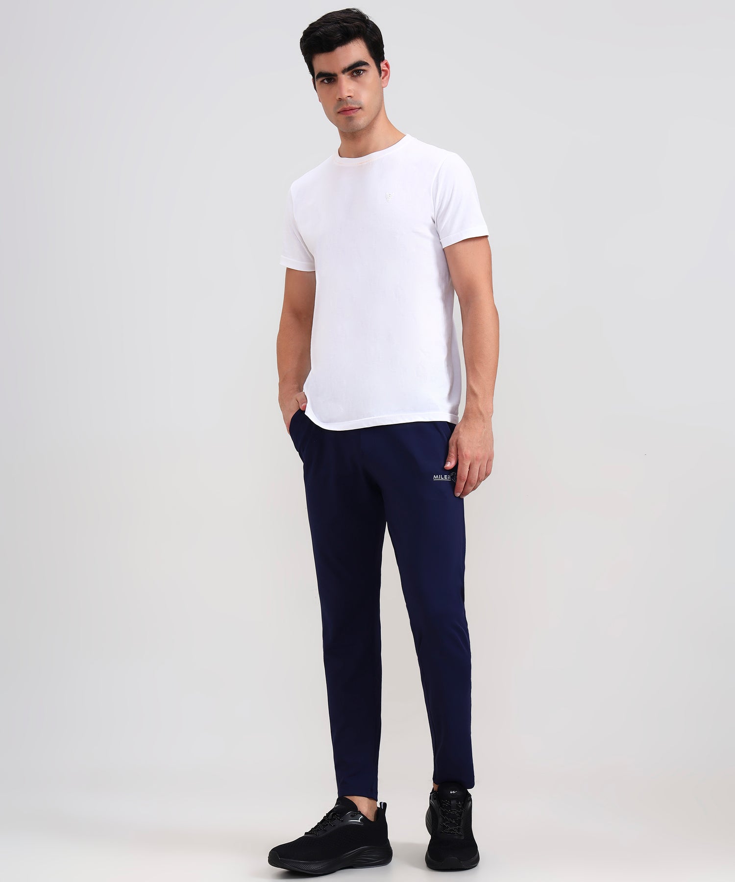 Men’s cross-pocket lowers in slim-fit design, premium cotton blend, casual athleisure wear on white background